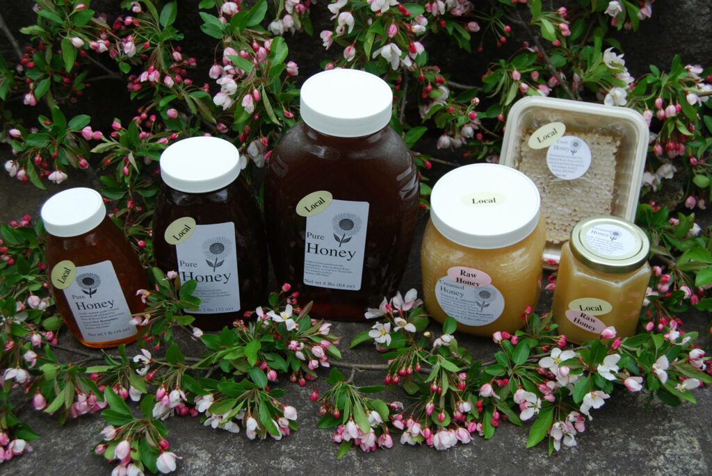 several jars of Peter's honey, including raw honey and creamed honey, and a package of comb honey